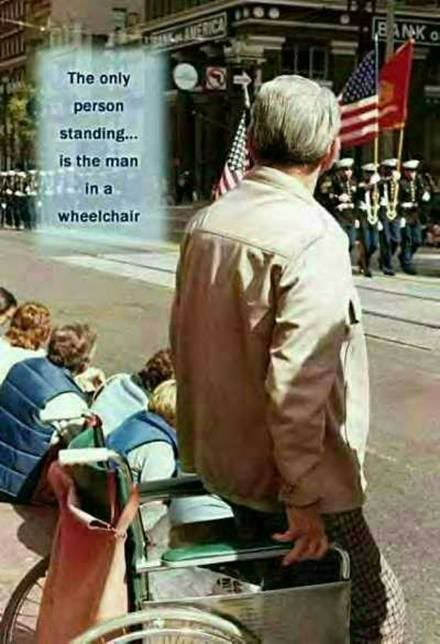 man in wheelchair stands up photo: vet stands for flag vetsalutesflag.jpg